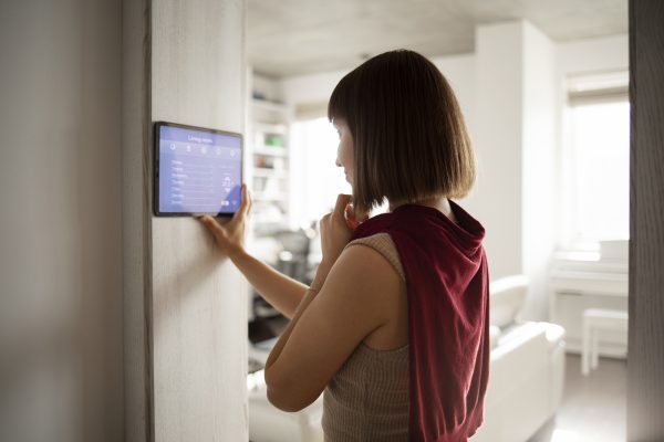 A close-up of a Tuya Wi-Fi multi-functional smart touch screen panel for central home control.